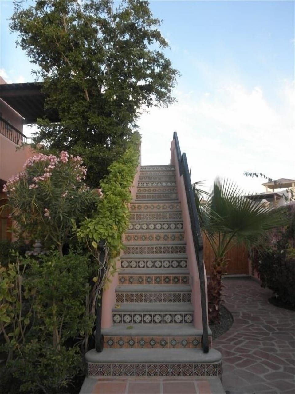 Tiled stairway to 2nd floor terrace, barbecue & lounge area, and master bedroom