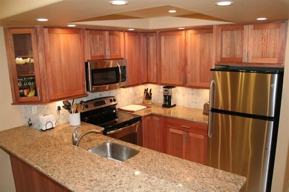 Stainless SteelAppliances, Granite Countertops, Lyptus Wood Cabinets, LED Lights