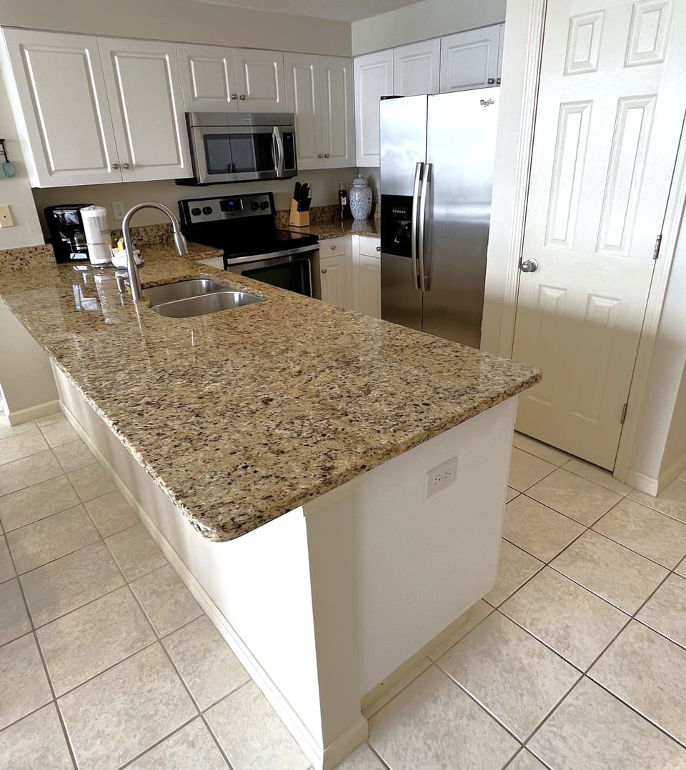 Granite counter tops with upgraded stainless appliances.