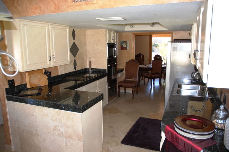 Kitchen has Dacor dbl ovens, granite counters & 6 burner stove top.
