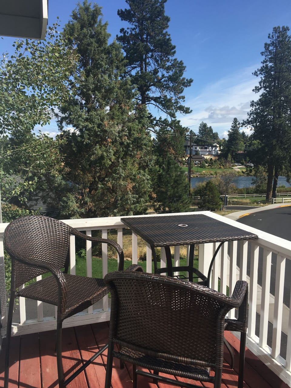 Deck with seating and BBQ overlooking park and river