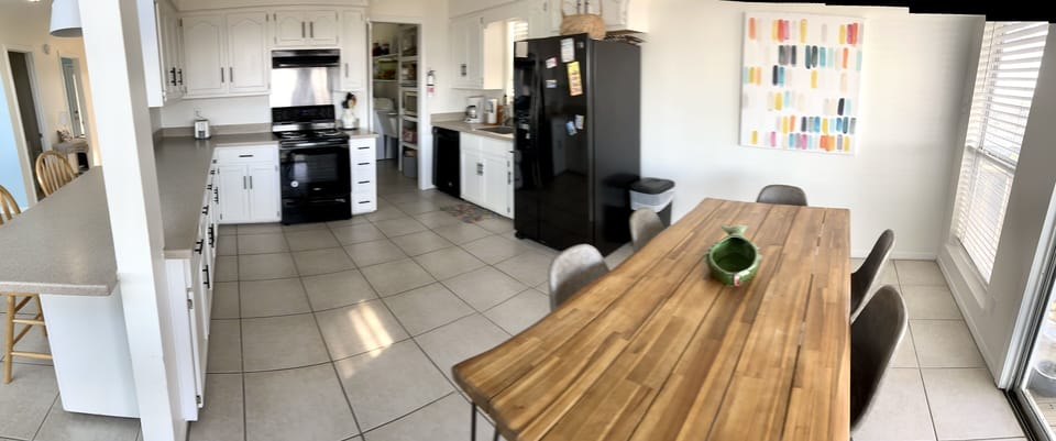 Open kitchen/dining area leads to our back deck through glass slider