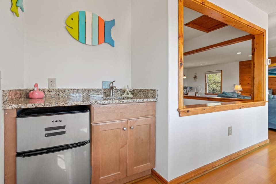 Small beverage fridge by dining table