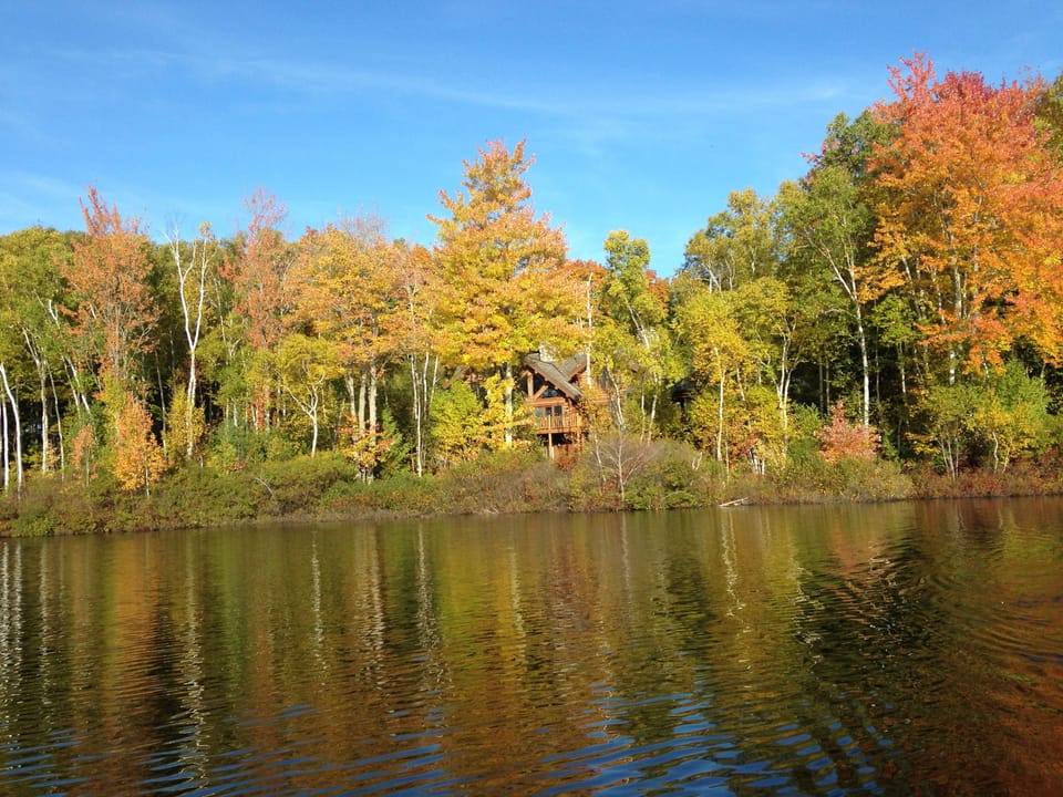 The home is nestled in the trees ~ right on the lake.