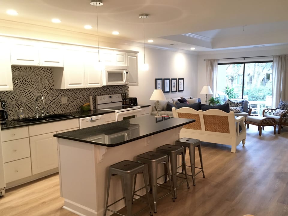 Beautiful renovated kitchen with island and granite countertops.