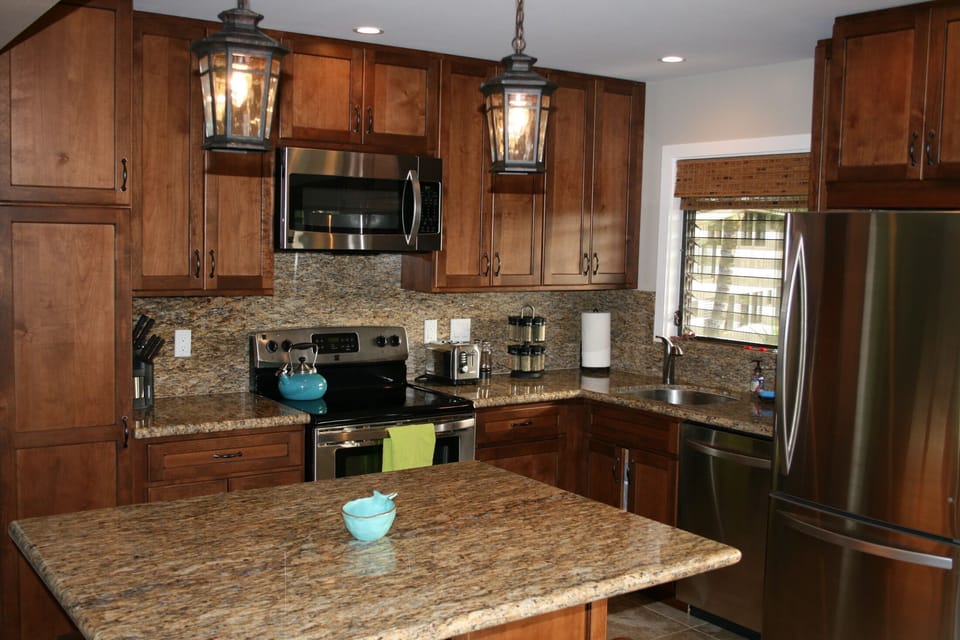 Remodeled kitchen w/stainless steel appliances, granite tops and island dining