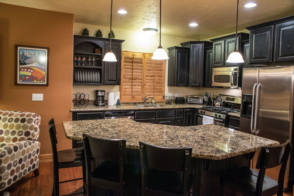 Kitchen- Granite topped island bar with seating for 4.