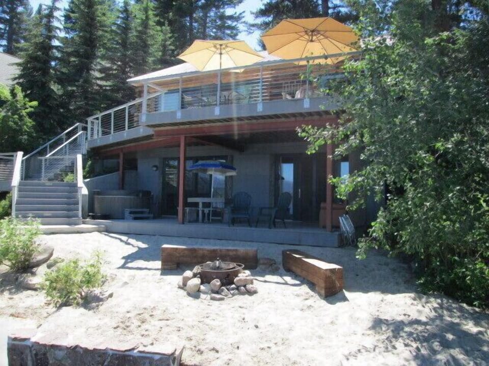 Lakefront view of house, upper & lower decks, sandy beach, firepit, hot tub