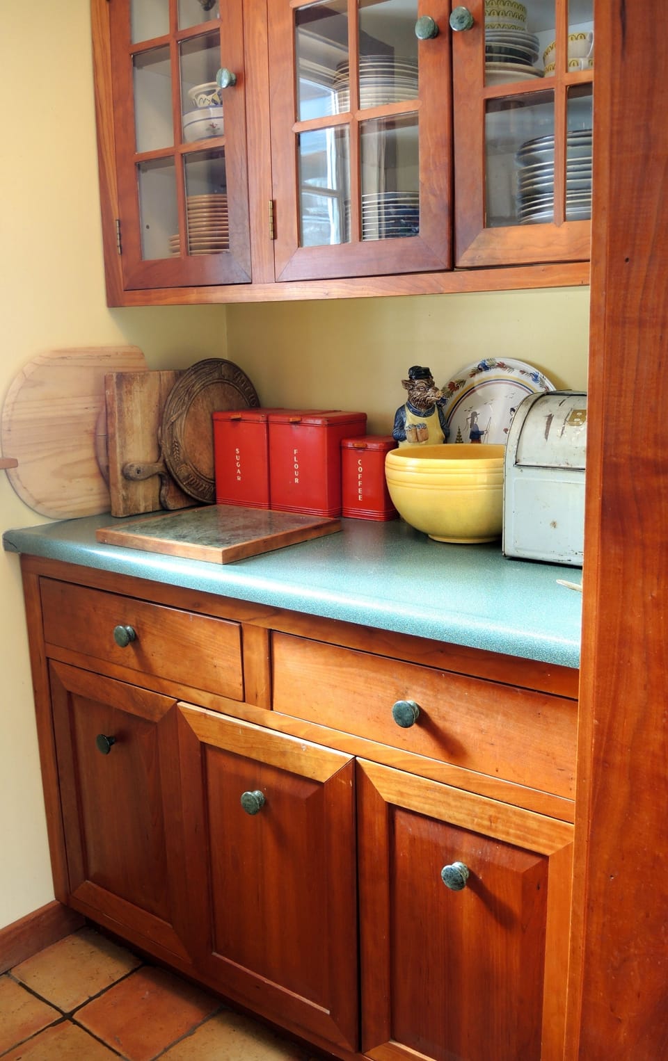 Pantry with plenty of storage for food and dishes. Custom wood and tile floor