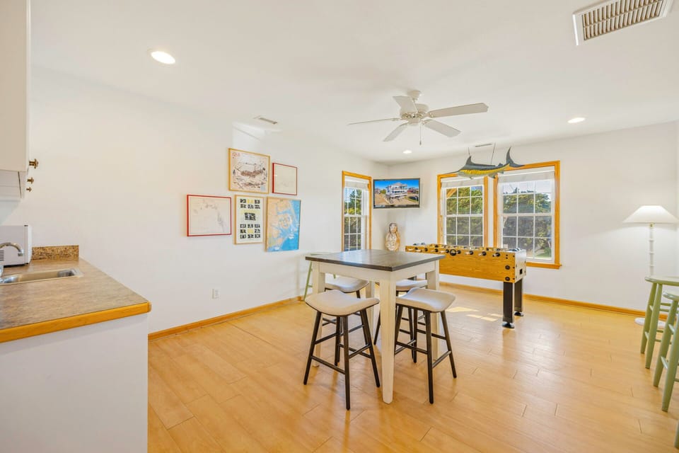 Unwind in this bright open-concept space where your morning coffee meets evening game nights, complete with foosball table.