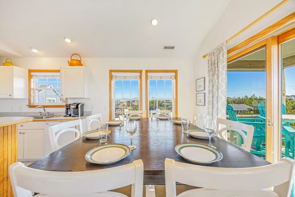 Gather around this spacious dining table where your group can enjoy meals together while soaking in stunning views through the large windows.