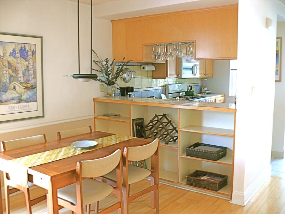 Dining area with full kitchen behind.