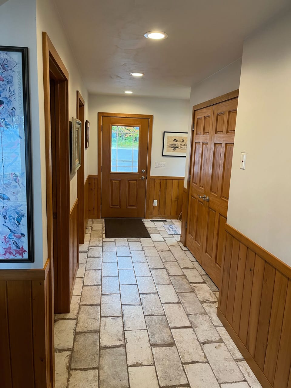 Entryway view with large double door closet on right side.