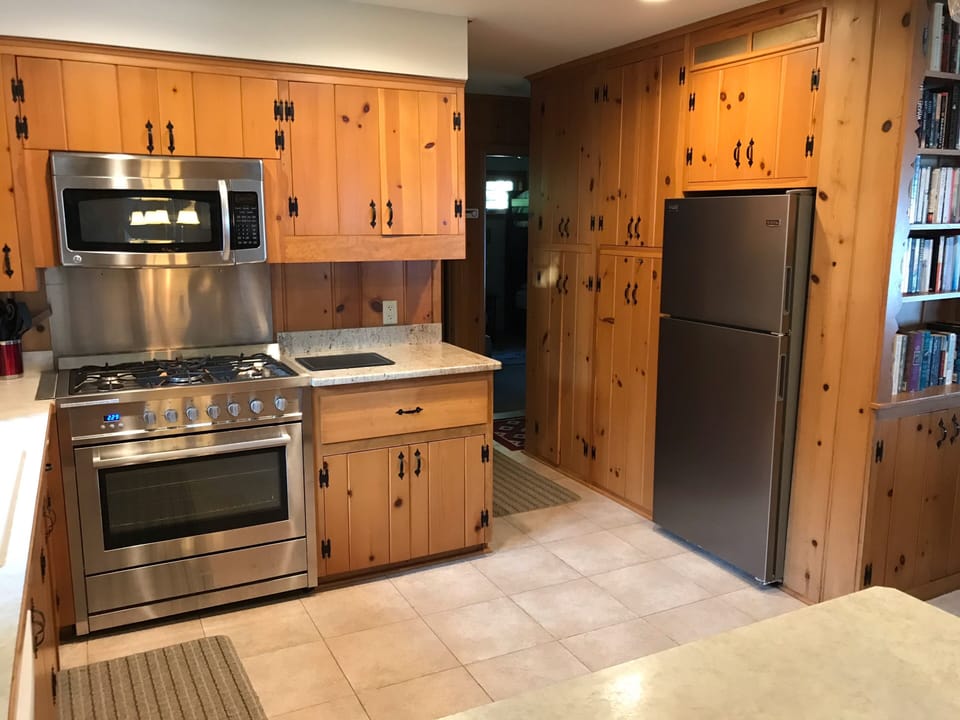 NEW stainless steel five burner stove, microwave, and refrigerator/ice maker