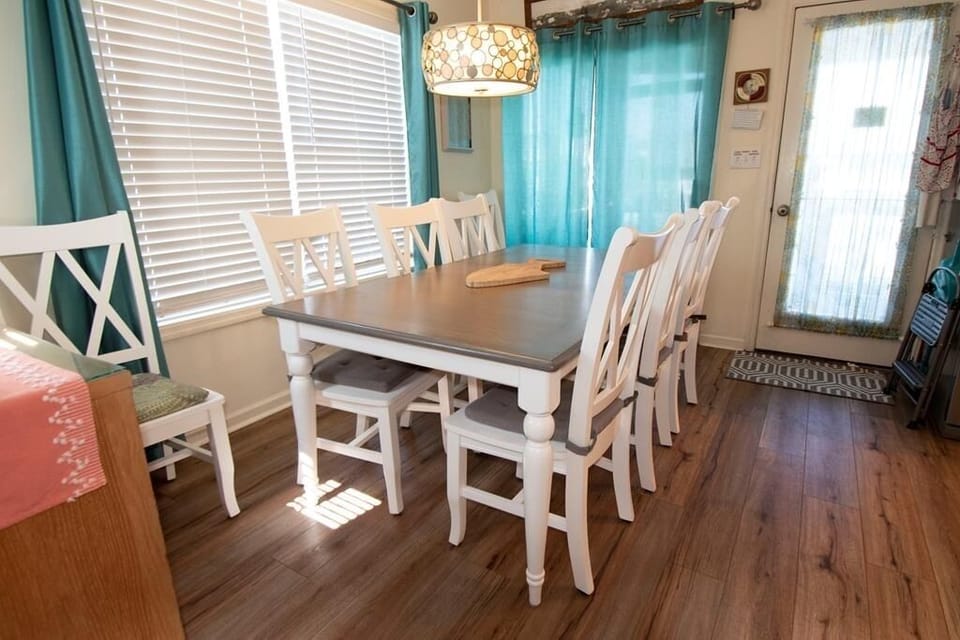 View of dining table and the back door to large rear deck with table for 14.