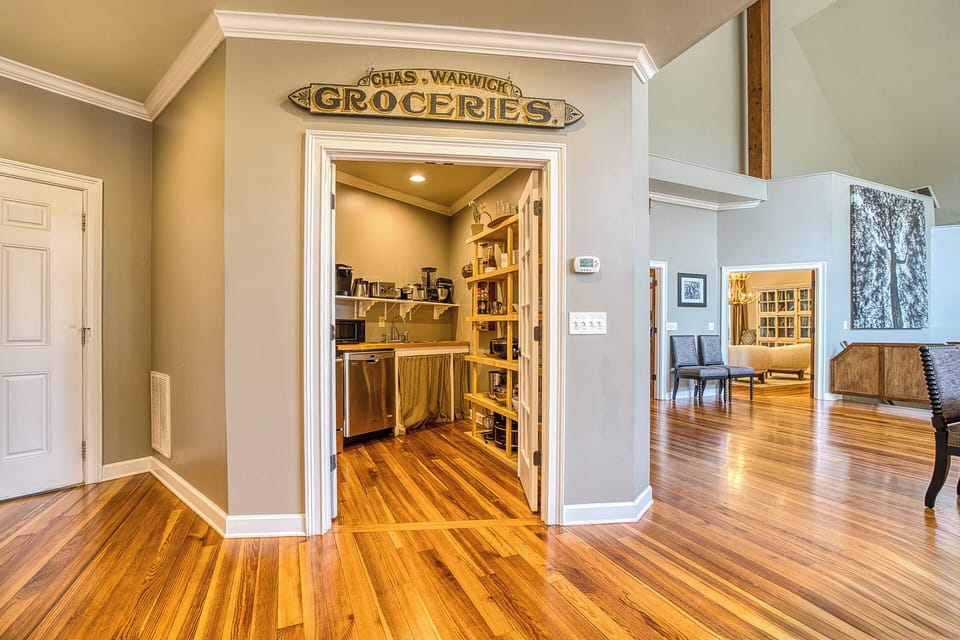 The butler's kitchen, conveniently located next to the main kitchen, features an added dishwasher—perfect for handling extra dishes and making meal prep a breeze for large gatherings!