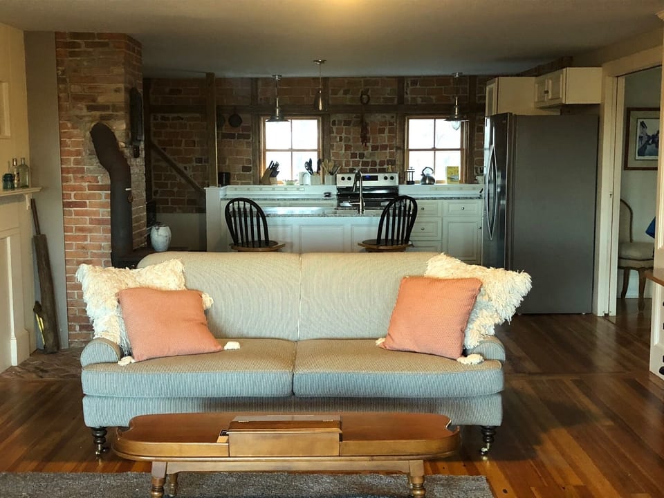 Family Room sofa and chairs look out on to the back yard and Marsh.