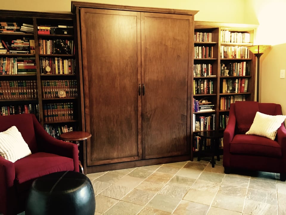 First floor bedroom library with french doors to yard
