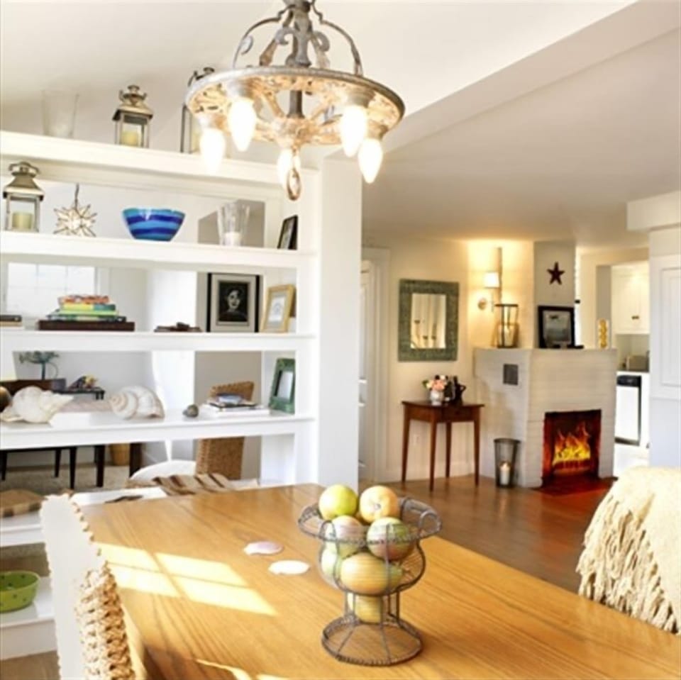 Dining table, office space behind bookcase, and view into new kitchen.