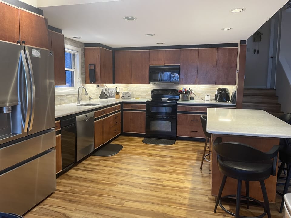 Kitchen with double oven, trash masher, dishwasher, microwave, air fryer, fridge