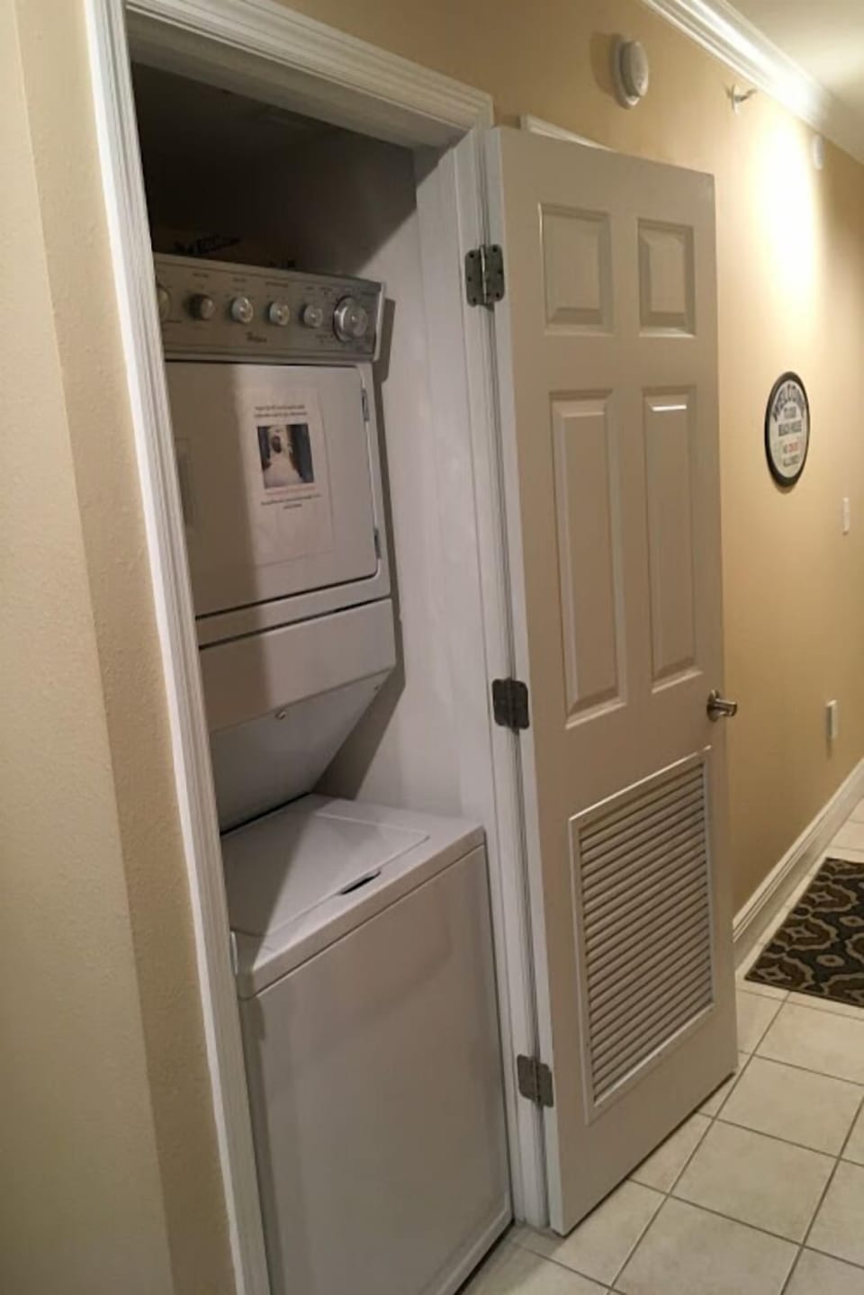 Stacked washer/dryer located in the main hallway. Close-able door blocks noise. 
