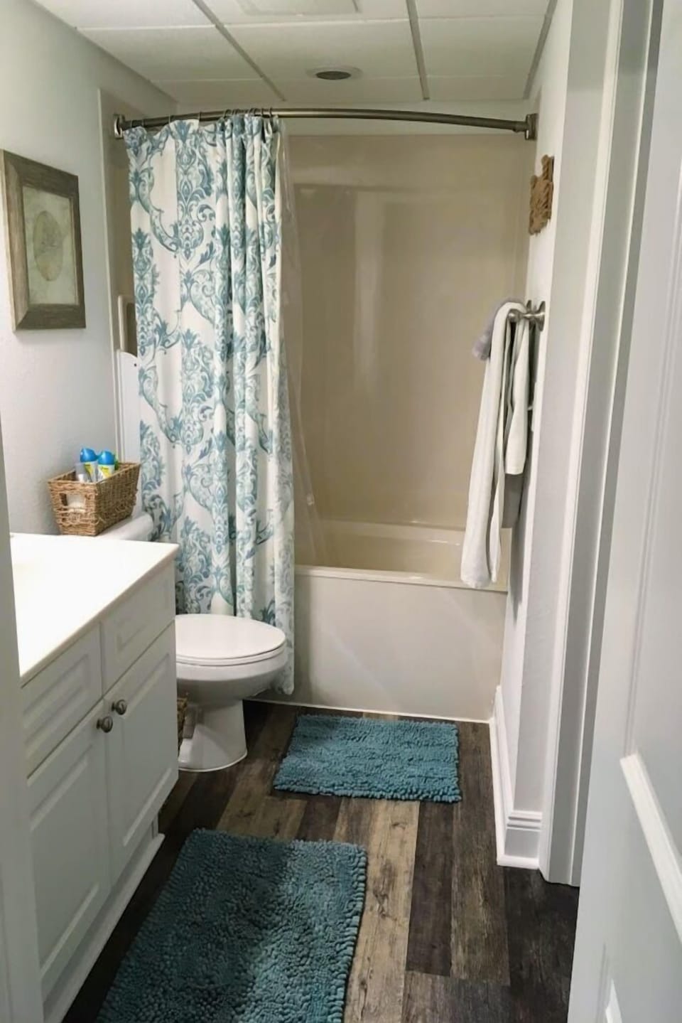Spacious bathroom with private access to bedroom and tons of towel hooks.