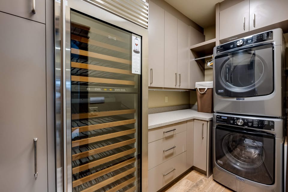 Laundry room with private washer, dryer, and wine fridge