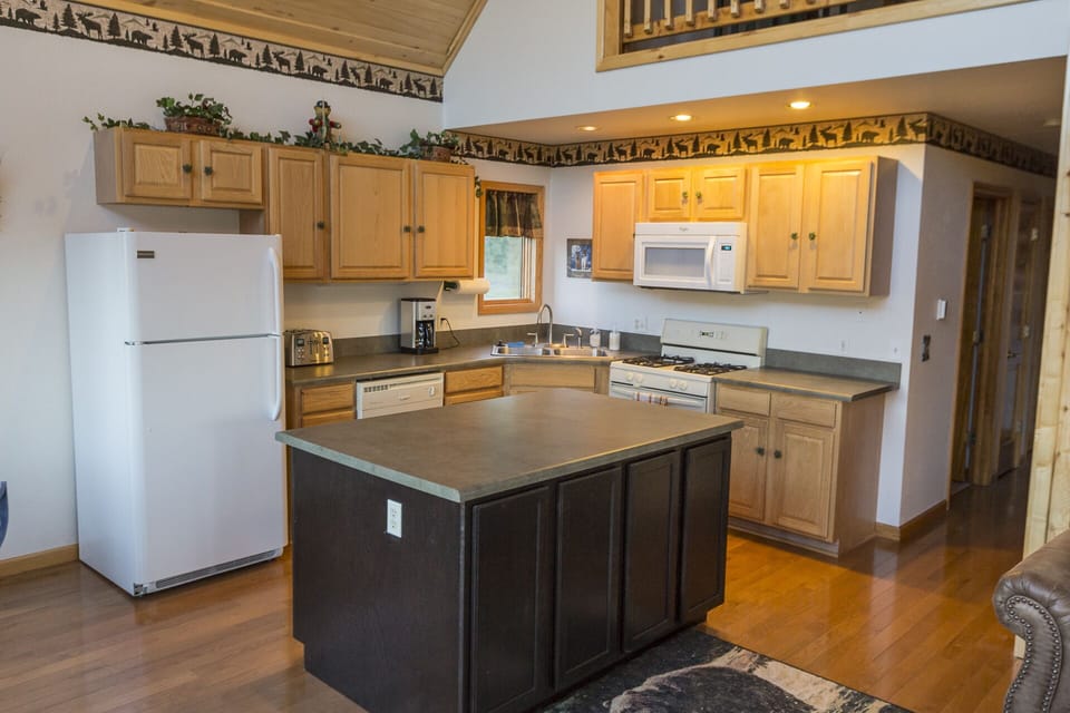 Fully stocked kitchen with custom island. 