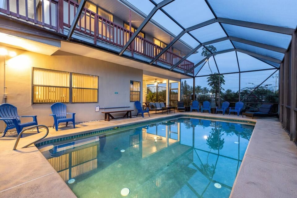 Comfortable and relaxing heated pool in screened pool house.