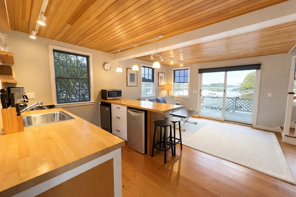 Inside is an open kitchen/ dining/ living area.