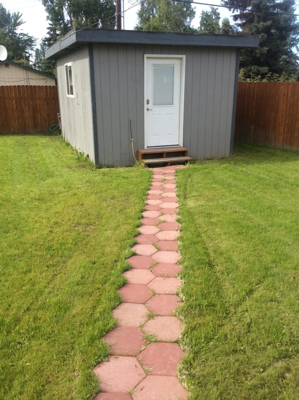 Backyard has inset pavers to the guest room.  Path to room #4.  