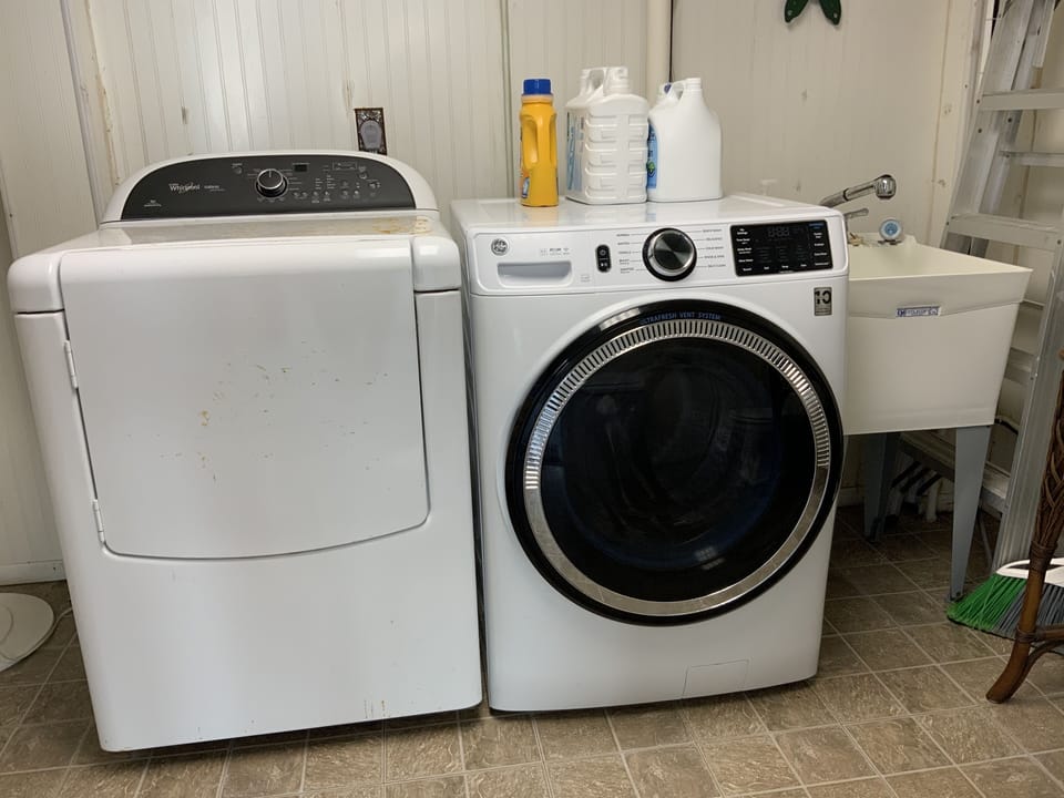 Laundry room washer and dryer with utility sink. 