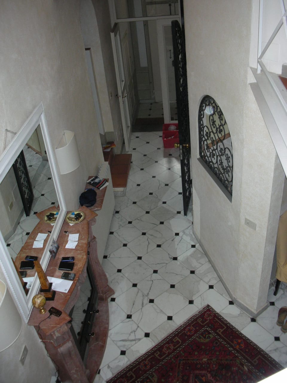 Hallway with fireplace - marble floors throughout.