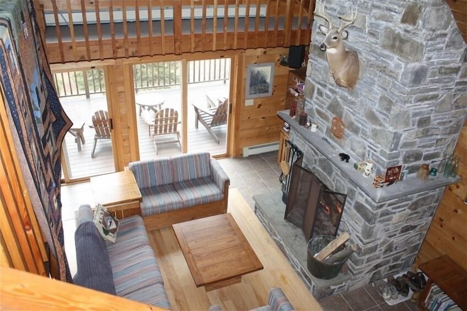 Comfortable living area with large stone  fireplace -- wood provided