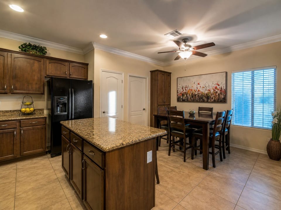 Spacious kitchen and dining area with granite island and seating for all.
