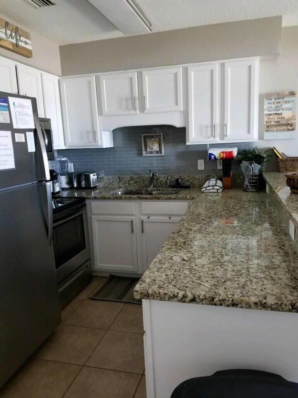 White cabinets, and stainless stove and microwave, dishwasher and refrigerator