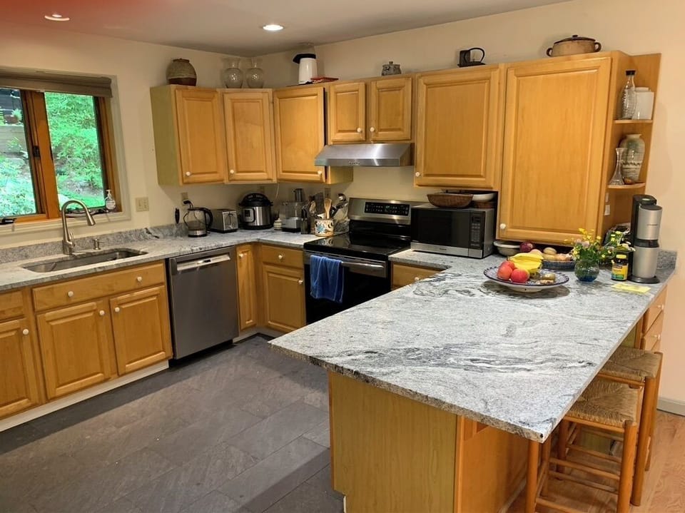 Granite counter island between kitchen and dinning room