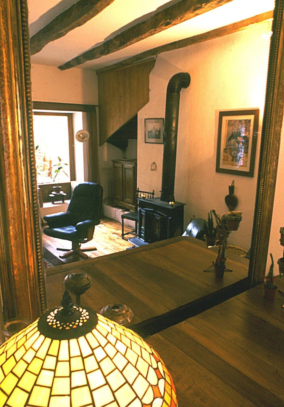 View of sunken living room with wood burning stove