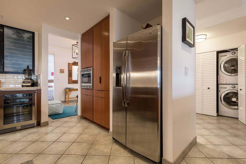 Perlick dual-zone beverage center on left with washer & dryer on right. 