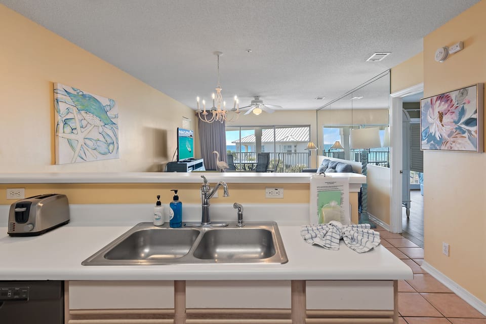 An open kitchen with a double sink and full appliances.