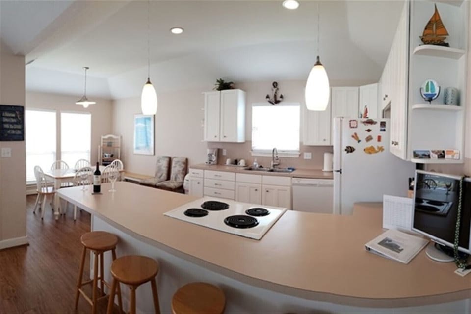 Fully stocked open kitchen with bar seating