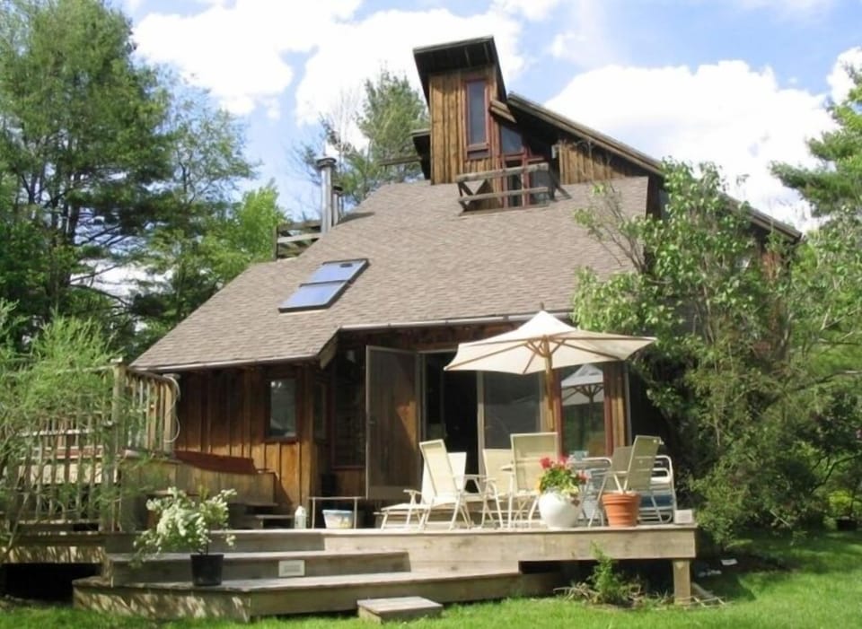 Summer: Back deck with Hot tub in rear. Looks out toward woods and lake outlet.