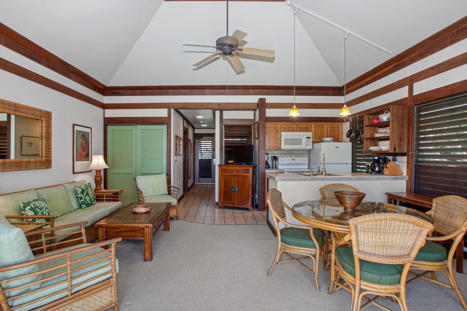 Traditional redwood trim, cathedral ceiling, and tropical furniture.