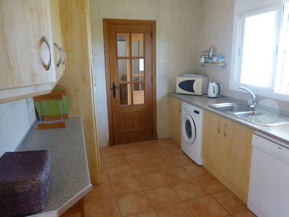 One end of kitchen, fridge to left  hand side