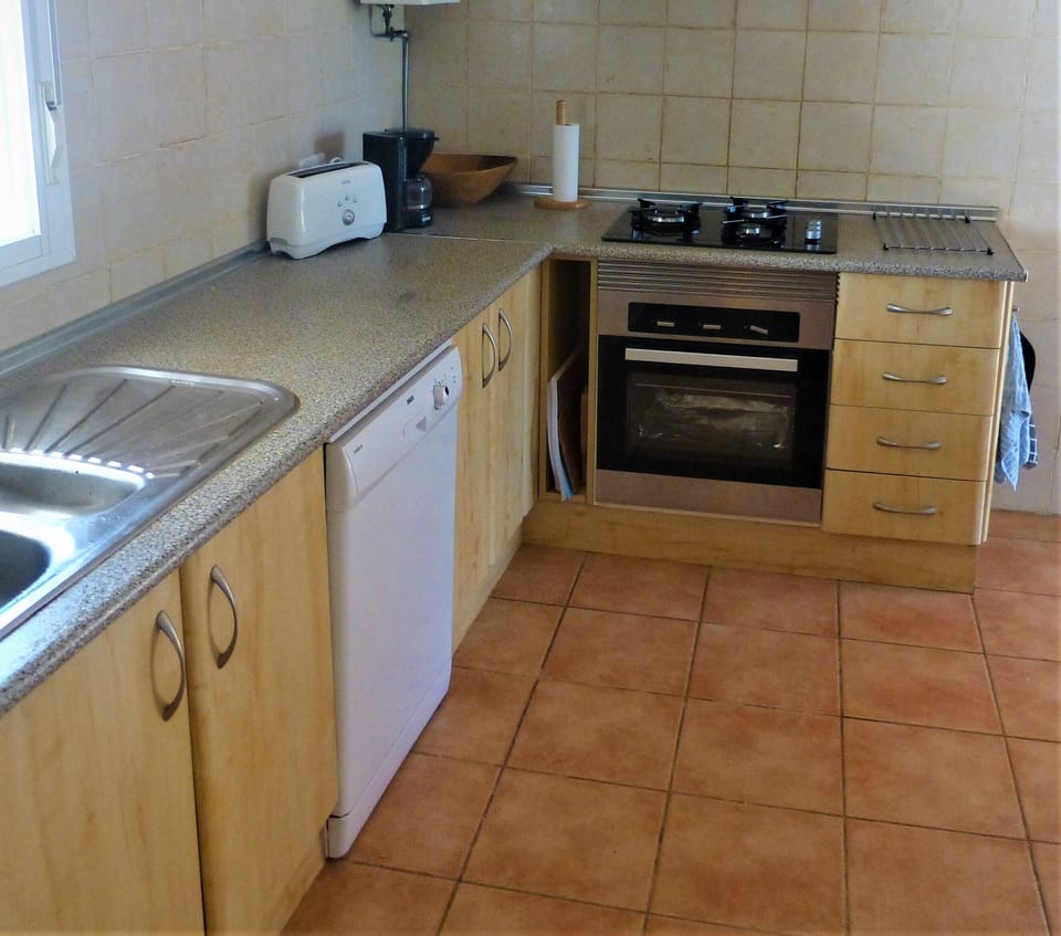 Other end of kitchen, dishwasher to left.