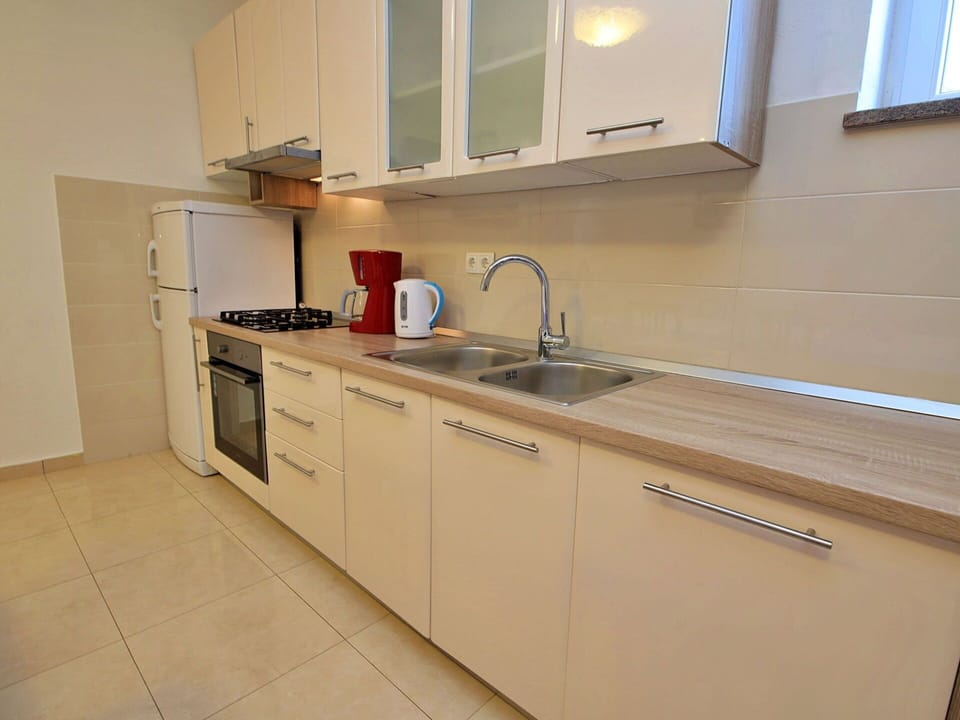 Tap, Sink, Countertop, Kitchen Sink, Cabinetry, Property, Plumbing Fixture, Building, Furniture, Window