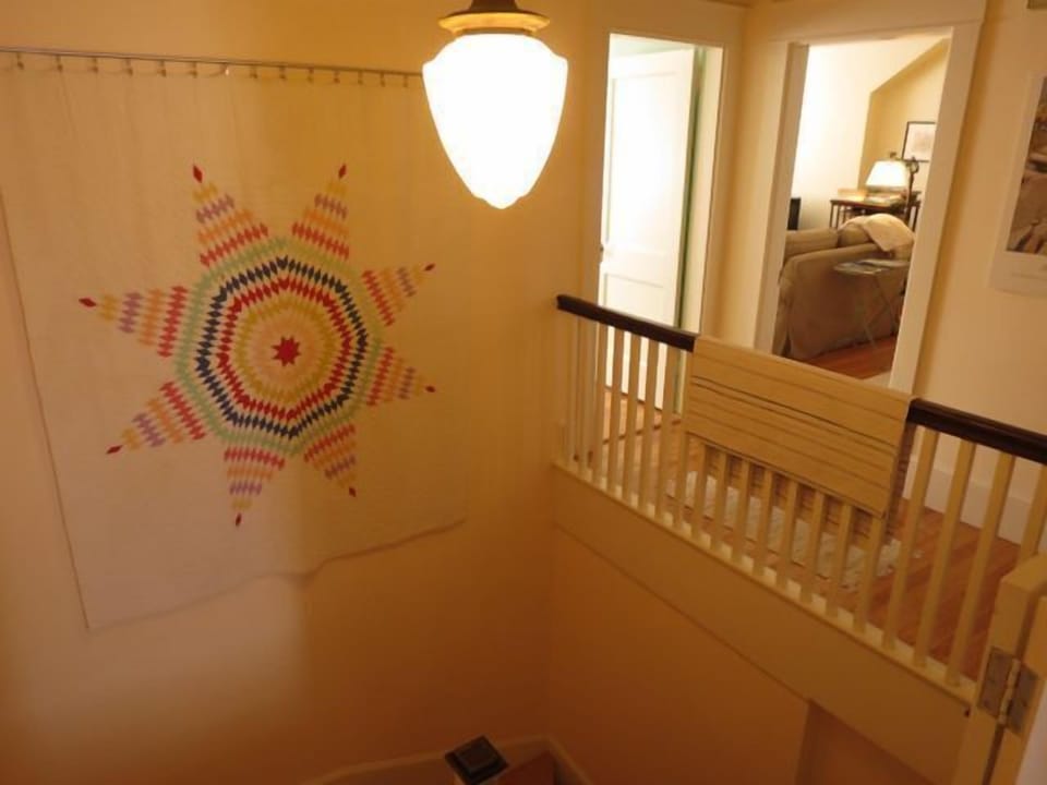 Front bedroom on left. Living room entrance off center gallery.