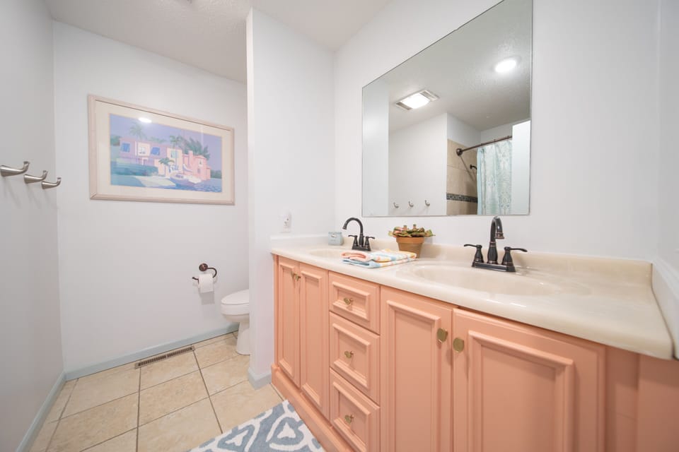 Main hall bathroom with double sinks. Shower seat available if needed.
