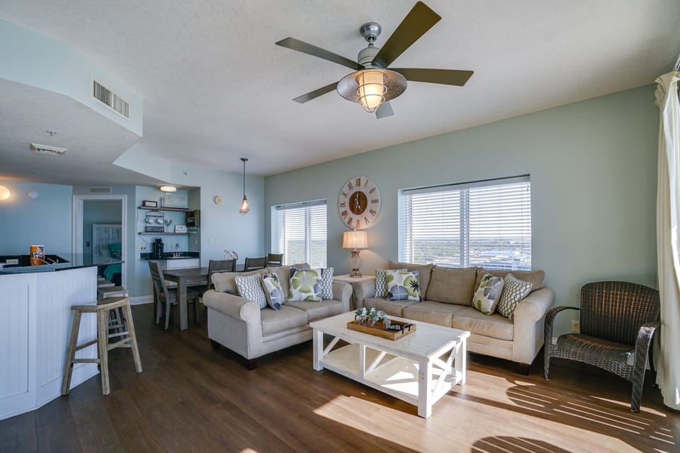 Relax in your spacious open-plan living area with comfortable seating, scenic views, and coastal-inspired décor that creates the perfect vacation atmosphere.