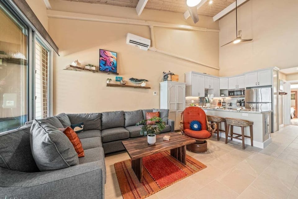 Alternate view of the living area with bar seating and open layout.